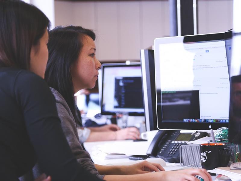 Two businesswomen looking at computer