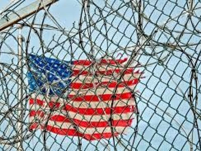 American Flag Behind Barbed Wire