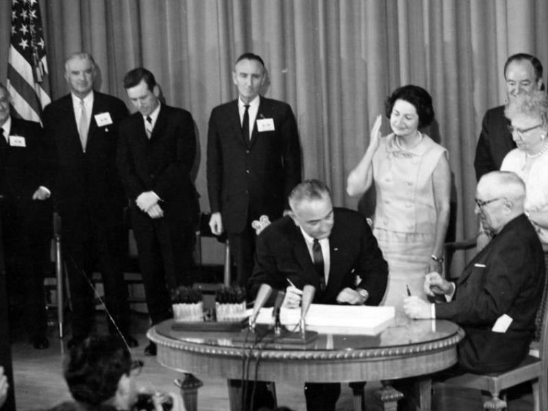 President Lyndon B. Johnson signs Medicare Bill