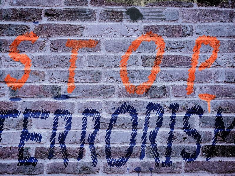 Wall with graffiti reading stop terrorism